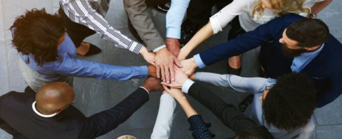 workers joining hands in a circle