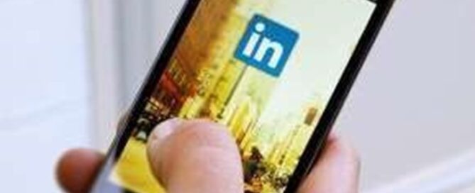 Person holding cell phone, LinkedIn app